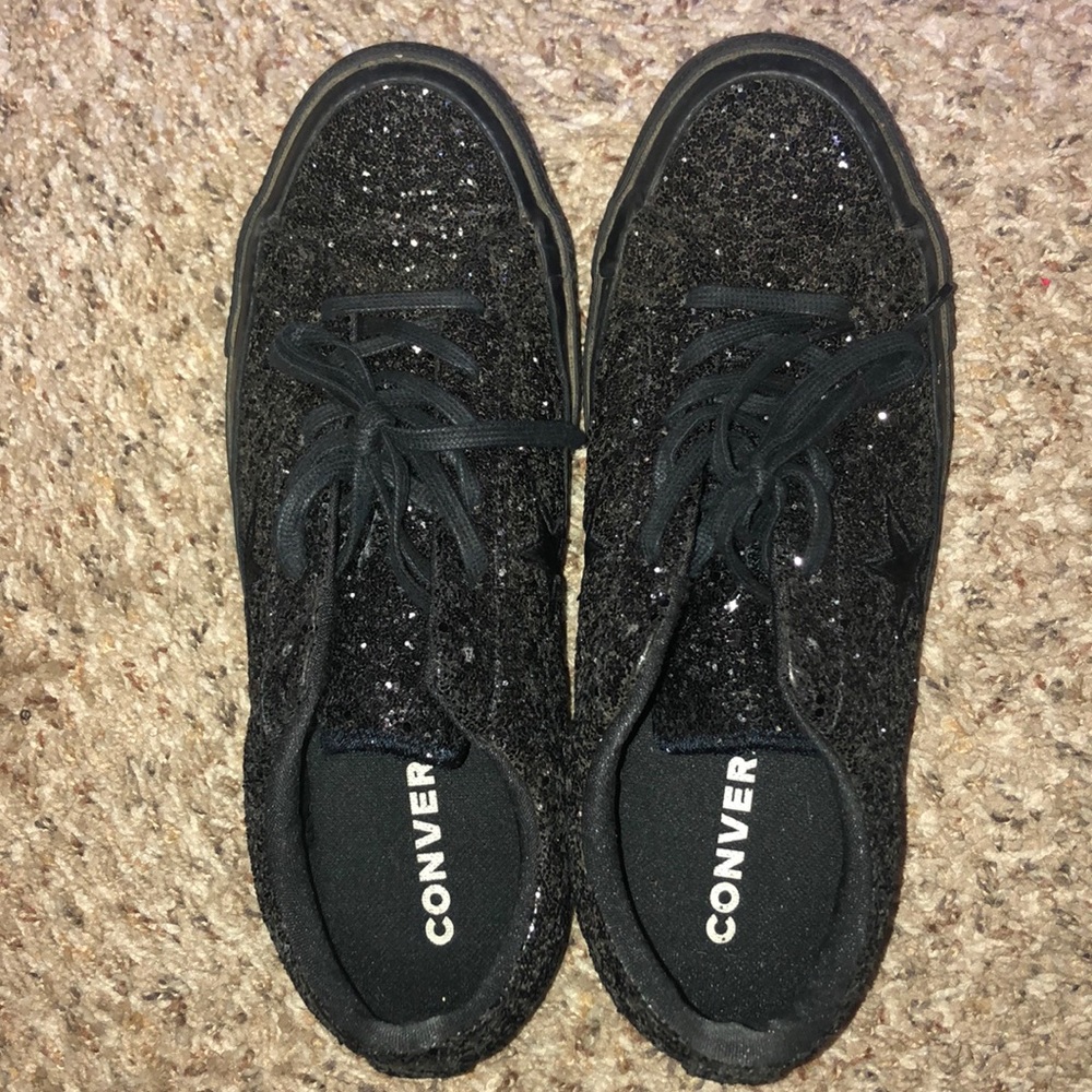All black glitter converse shoes.